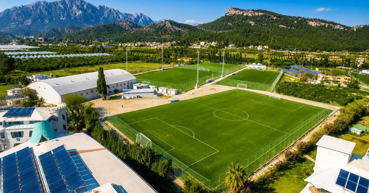 Aerial view of Kemer football training complex with Taurus Mountains backdrop, Antalya